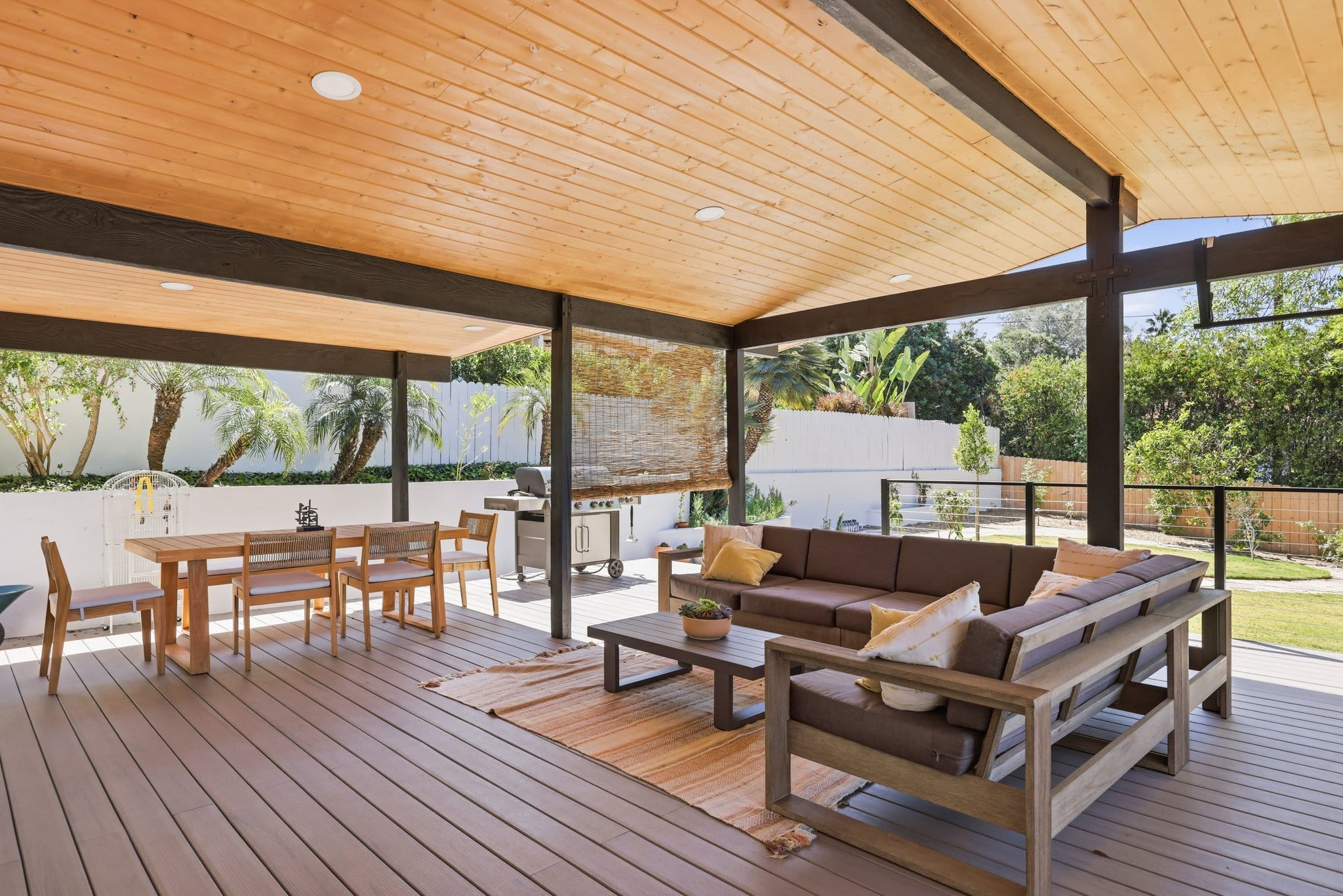Covered backyard patio with cedar tongue-and-groove ceiling, composite decking and outdoor lounge seating