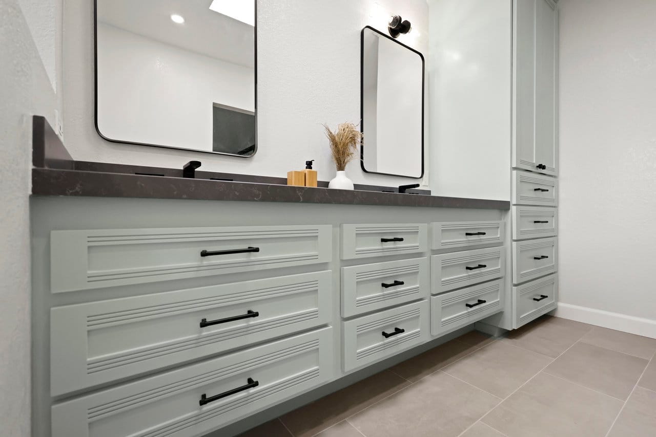 Long floating vanity in sage with fluted drawers and gray stone countertop