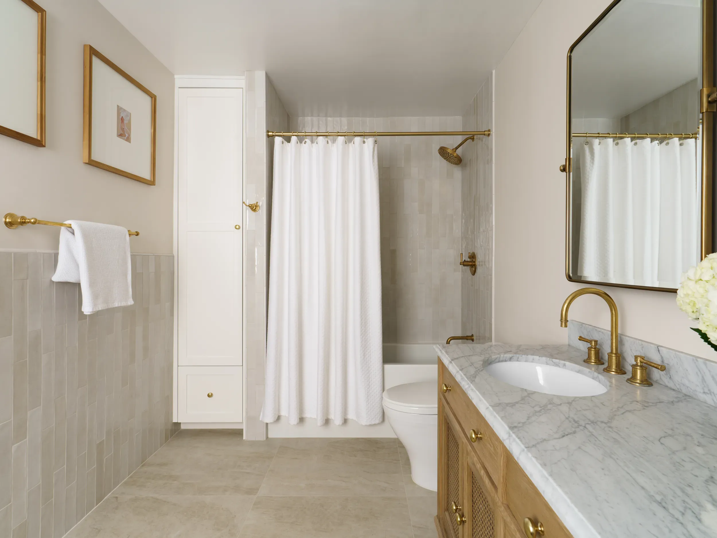 Neutral bathroom with soaking tub, oak vanity and brushed brass fittings
