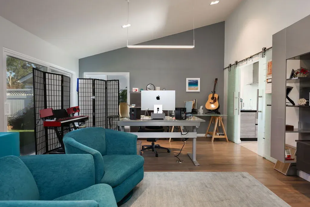 Remodeled home office and studio with vaulted ceiling and sliding barn door
